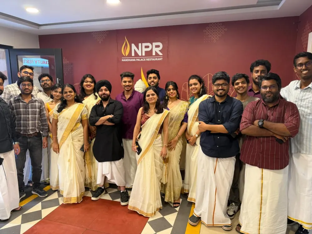 Zethic team in traditional Onam attire at a restaurant dinner