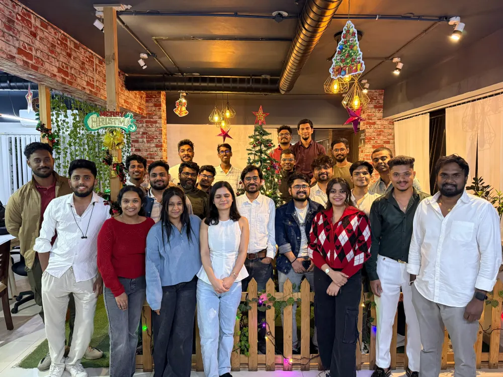 Zethic team group photo in front of Christmas decorations